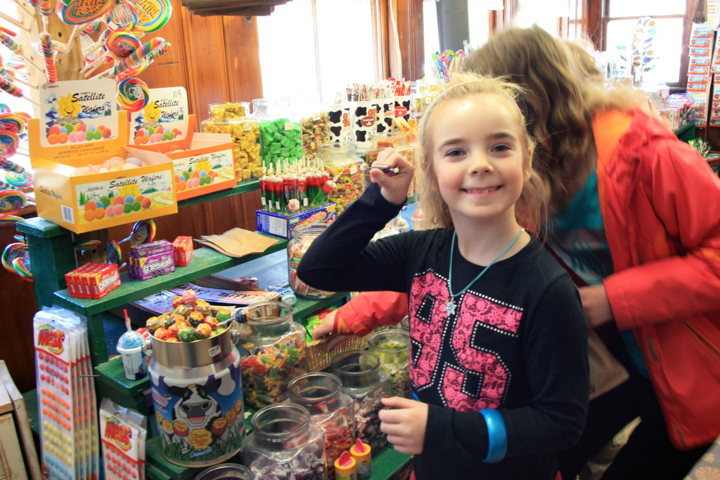 Young Girl holding candy in Calef's Candyland