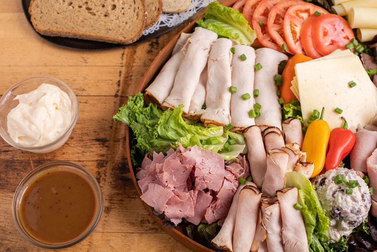Calef's Deli Platter with cheese, sliced meats, deli salads, and veggies